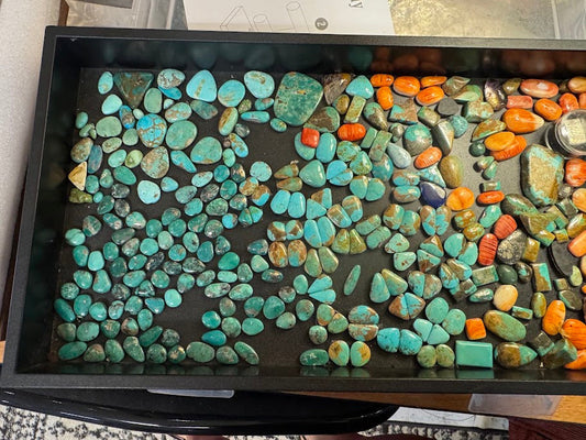 Assorted turquoise cabochons showing different colors, shapes and matrix patterns